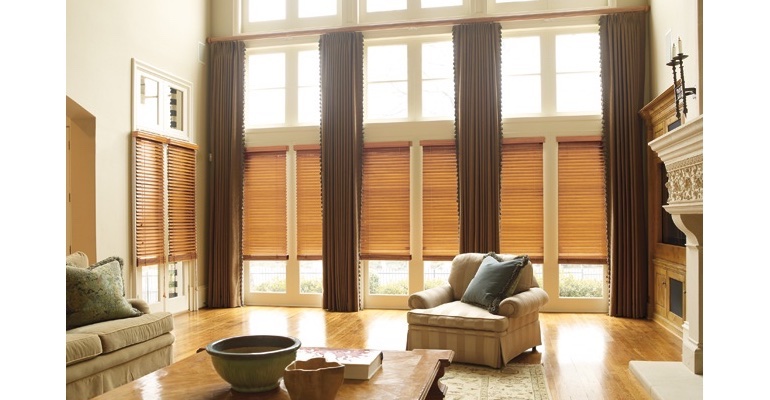 New Brunswick great room with wooden blinds and full-length draperies.